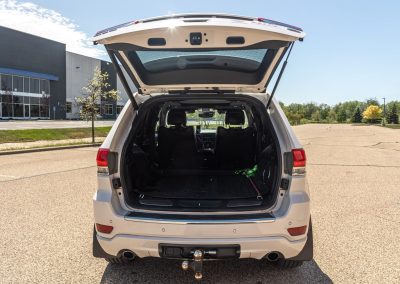 Rear hatch open on an Elite Transportation Systems Jeep showing the empty cargo area and tow hitch