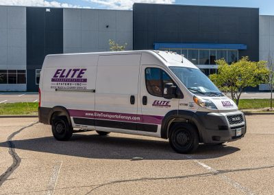 Elite Transportation Systems high-roof sprinter cargo van parked outside an office building